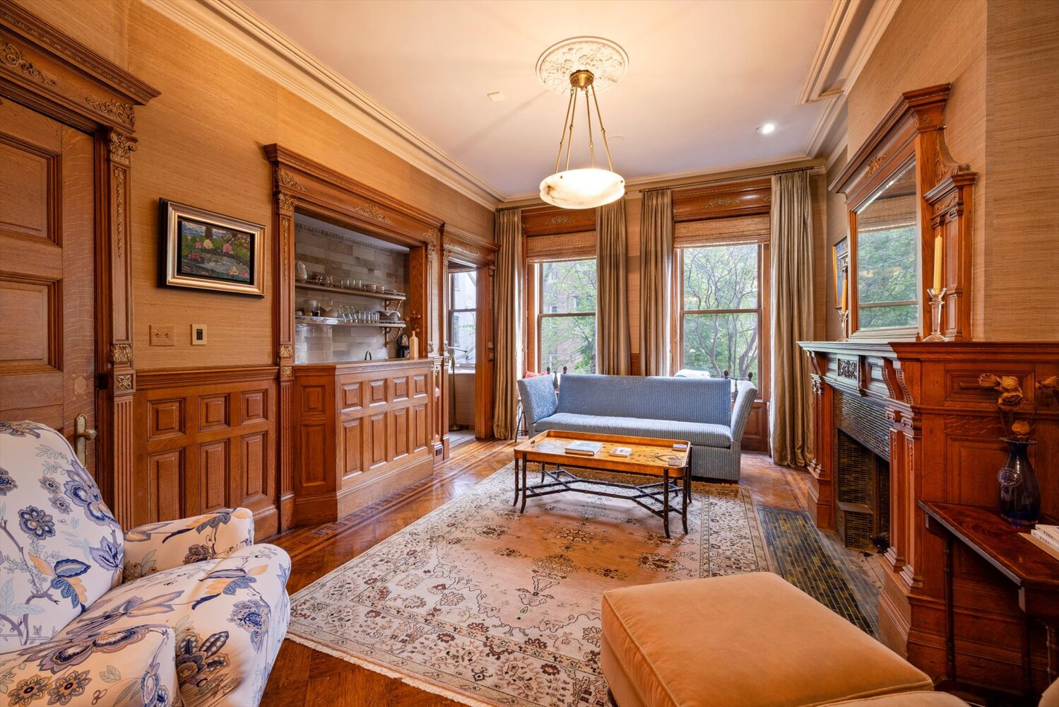 329 Convent Avenue Manhattan, NY 10031 - Photo 5 of 28 a living room with furniture a rug and a large window