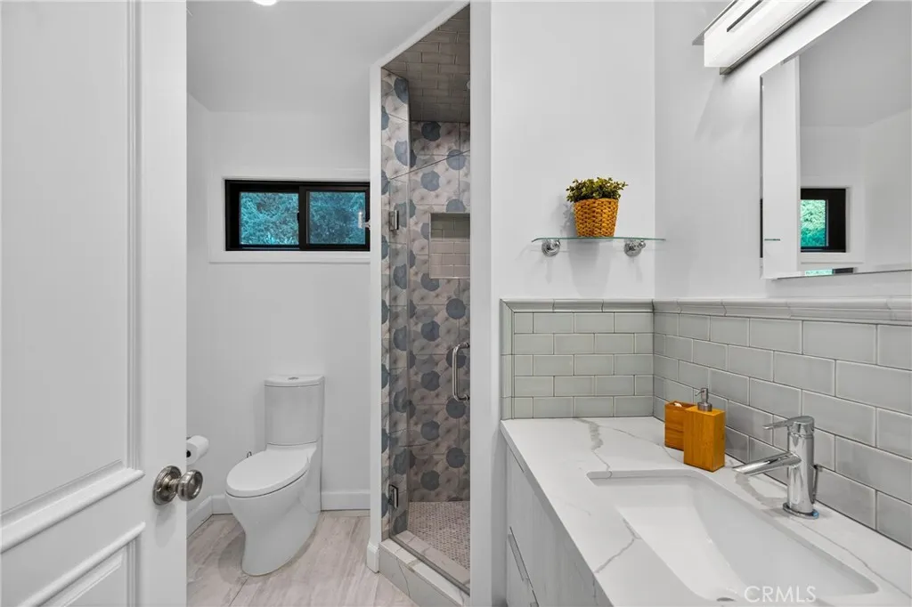 7572 McGroarty Terrace Los Angeles, CA 91042 - Photo 18 of 47 a bathroom with a sink a toilet and shower