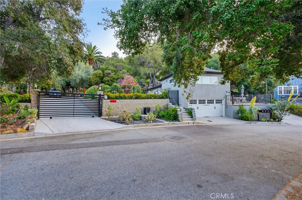7572 McGroarty Terrace Los Angeles, CA 91042 - Photo 46 of 47 a front view of a house with a yard and a garage