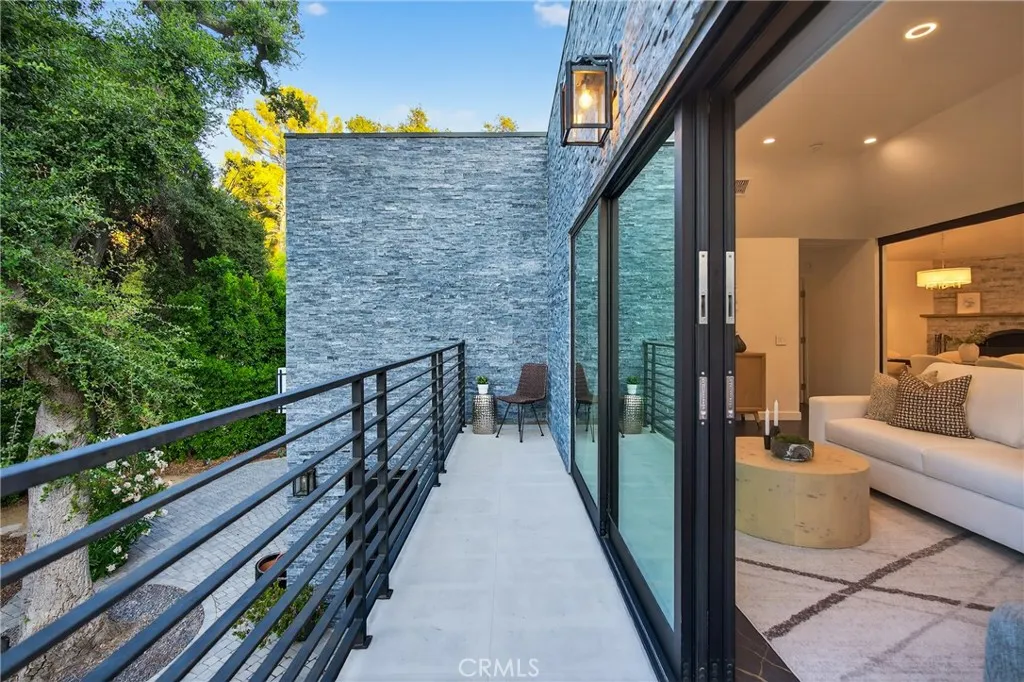 7572 McGroarty Terrace Los Angeles, CA 91042 - Photo 5 of 47 a view of a balcony with couches and wooden floor