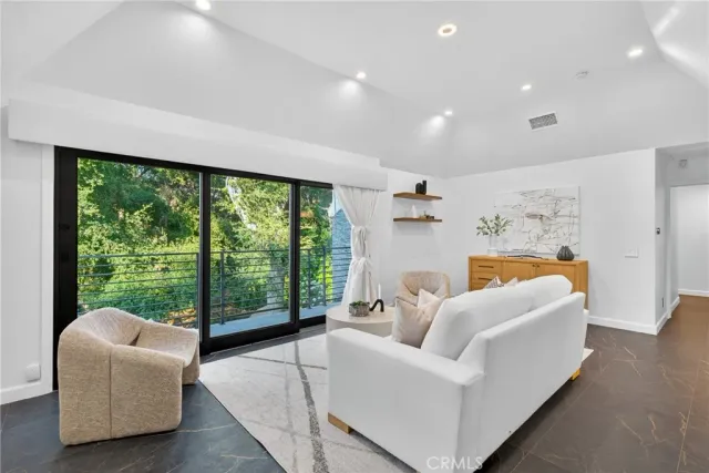 a living room with furniture and a clock