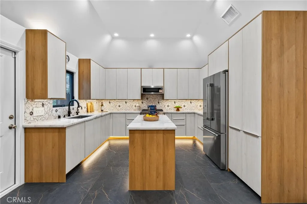 7572 McGroarty Terrace Los Angeles, CA 91042 - Photo 8 of 47 a kitchen with refrigerator and cabinets