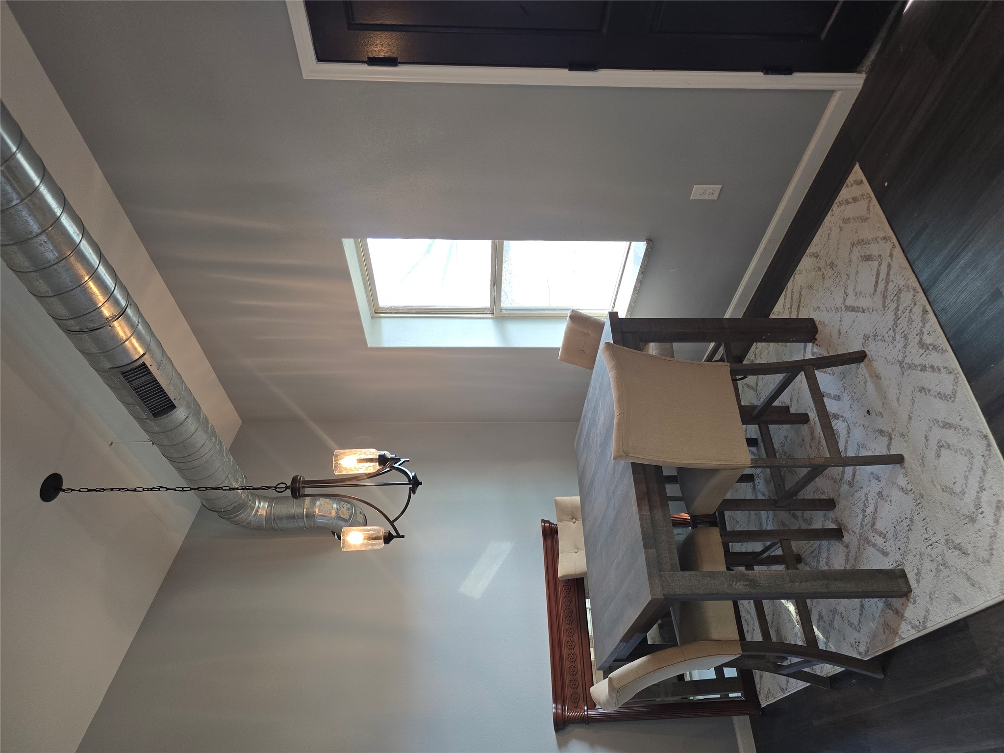 304 Spring Street Burnet, TX 78611 - Photo 8 of 11 Dining space featuring hanging lights and dark wood-type flooring