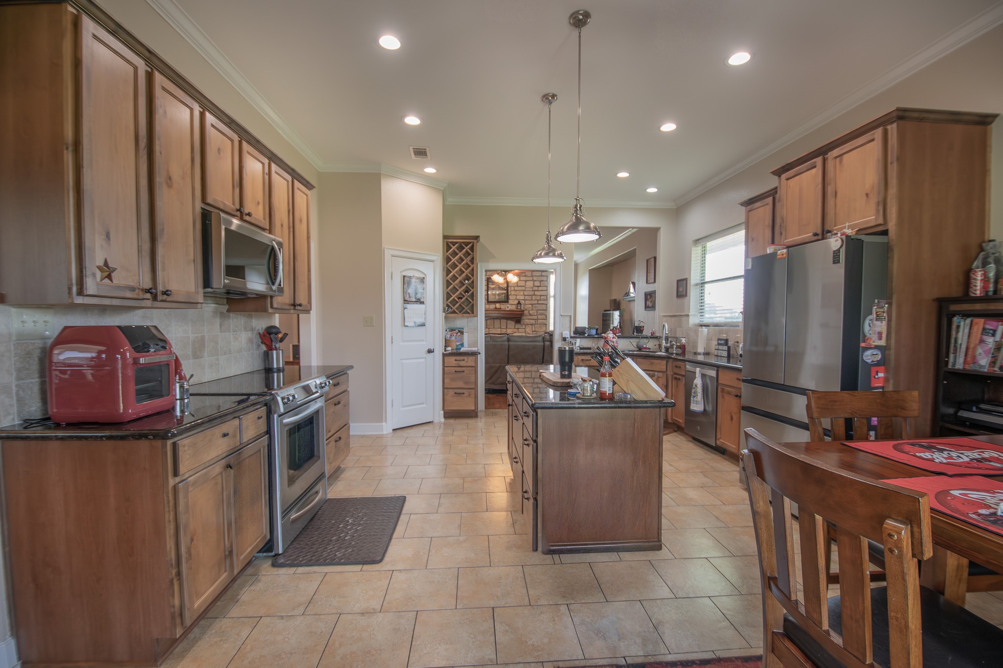 302 Mayad Boulevard Rosharon, TX 77583 - Photo 13 of 42 a kitchen with stainless steel appliances granite countertop a stove refrigerator and a sink