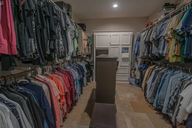 a bedroom with a bed and a chair