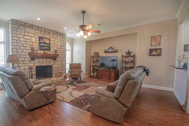 a living room with furniture a fireplace and a flat screen tv