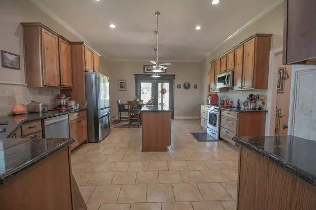 a kitchen with a sink counter top space appliances and cabinets