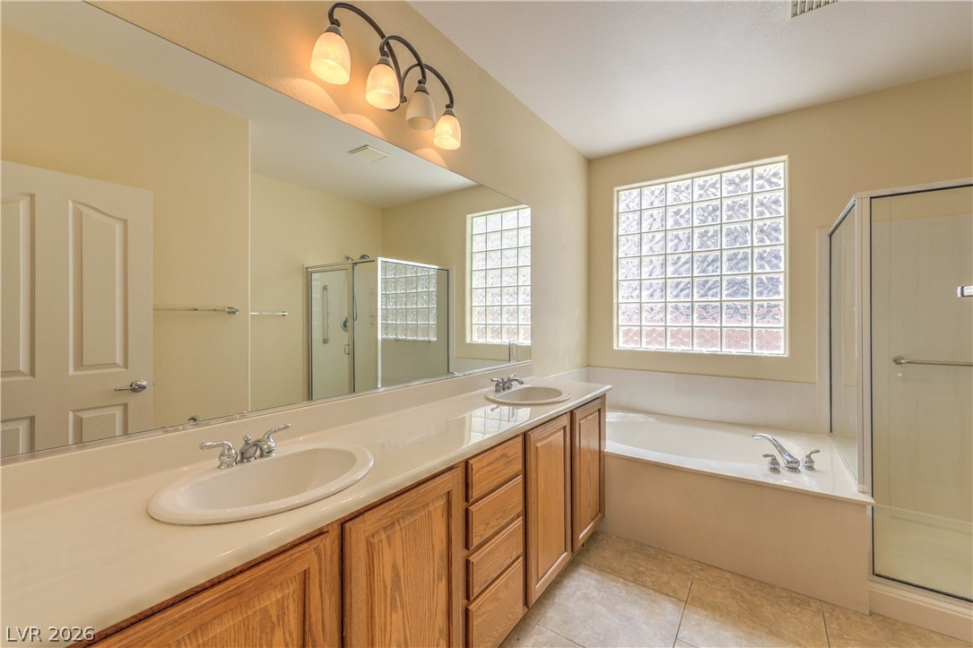 2276 Saxtons River Road Henderson, NV 89044 - Photo 19 of 49 Bathroom with Raised Vanity, Dual Sinks, Garden Tub, and Separate Shower