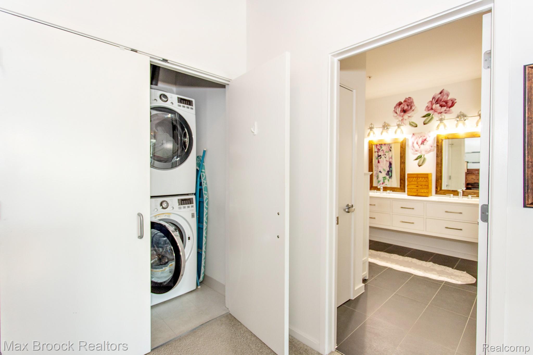211 East 9 Mile Road, Unit 307 Ferndale, MI 48220 - Photo 35 of 60 Laundry area featuring stacked washer and dryer