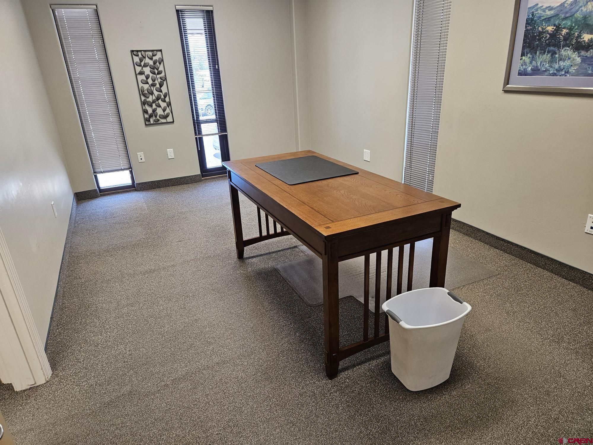 132 East 5th Street, Unit 201 Delta, CO 81416 - Photo 3 of 8 a dining room with a table and white walls