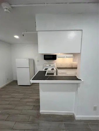 a stove top oven sitting inside of a kitchen