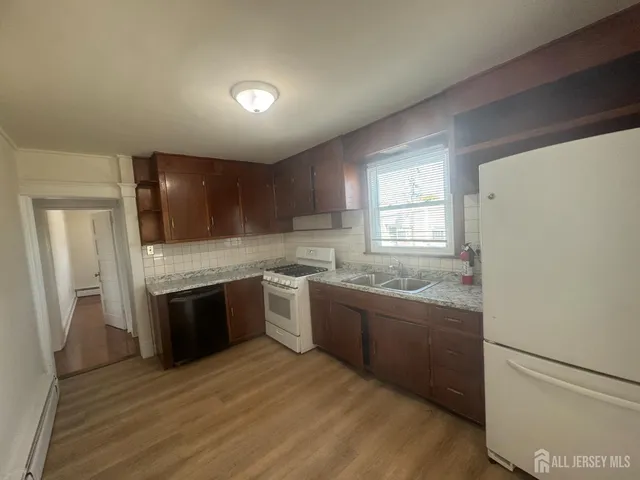 a kitchen with stainless steel appliances granite countertop a sink and a stove top oven