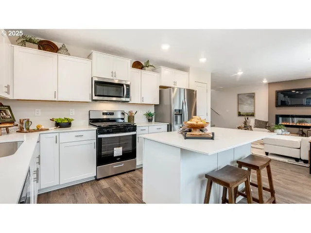a kitchen with appliances a sink and cabinets