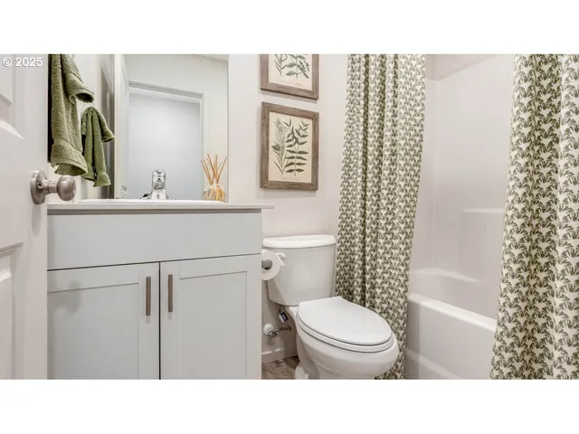 a bathroom with a toilet a sink and a mirror