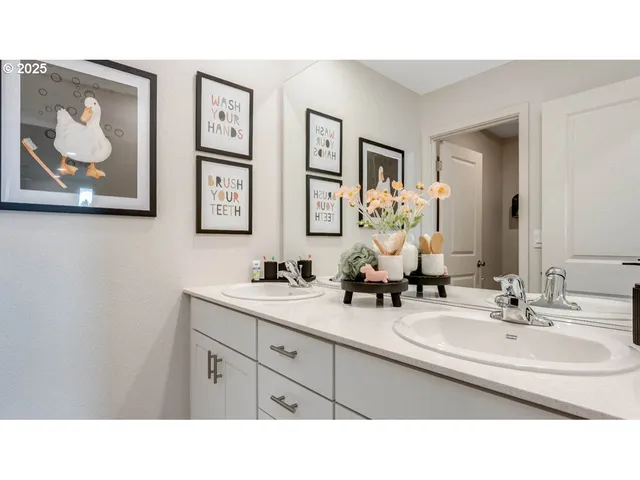 a bathroom with a sink a mirror and a painting on the wall