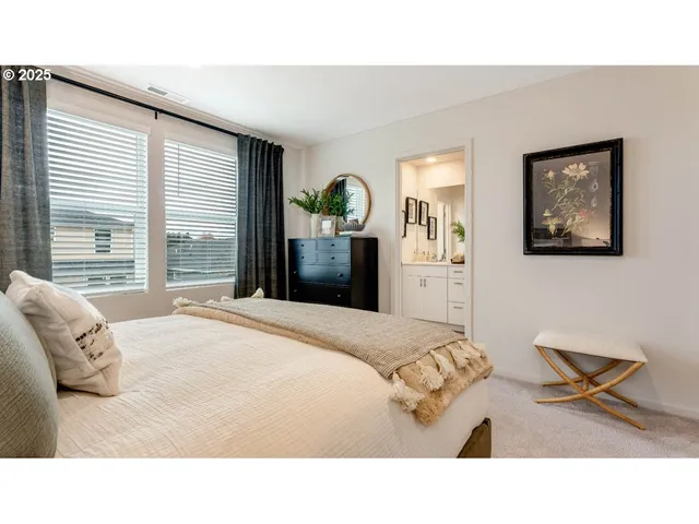 a living room with a bed furniture and a window