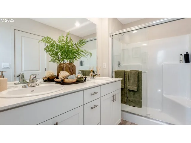 a bathroom with a sink a mirror and a shower