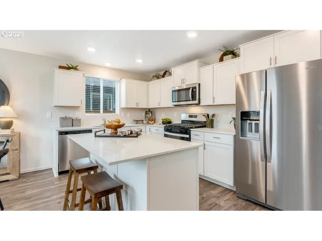 a kitchen with refrigerator cabinets and a sink