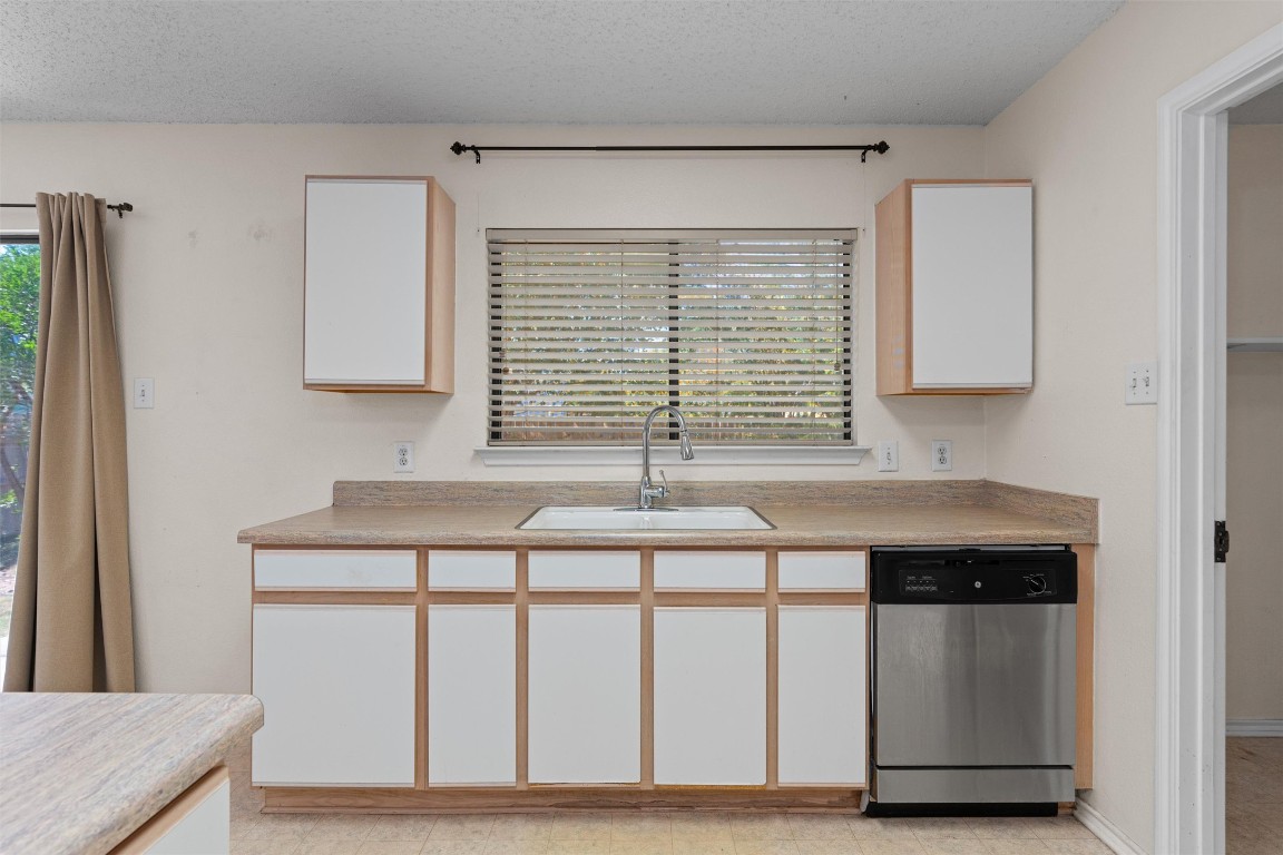 1353 Lakeside Loop Round Rock, TX 78665 - Photo 12 of 29 a kitchen with a wooden floor and a window