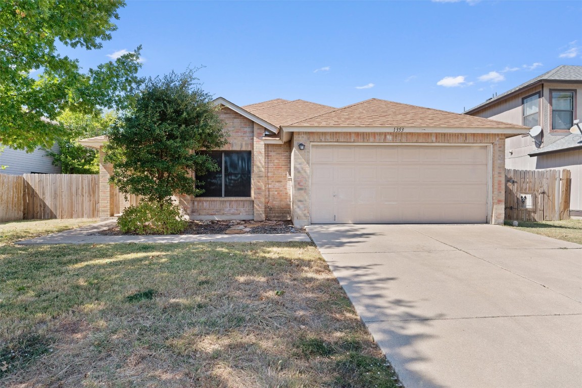 1353 Lakeside Loop Round Rock, TX 78665 - Photo 2 of 29 a front view of a house with a yard and garage