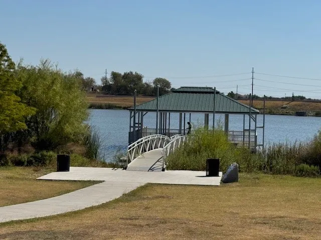 a view of a swimming pool with a patio and a yard