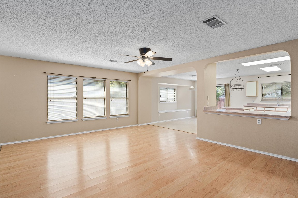 1353 Lakeside Loop Round Rock, TX 78665 - Photo 7 of 29 a view of an empty room with a window and wooden floor