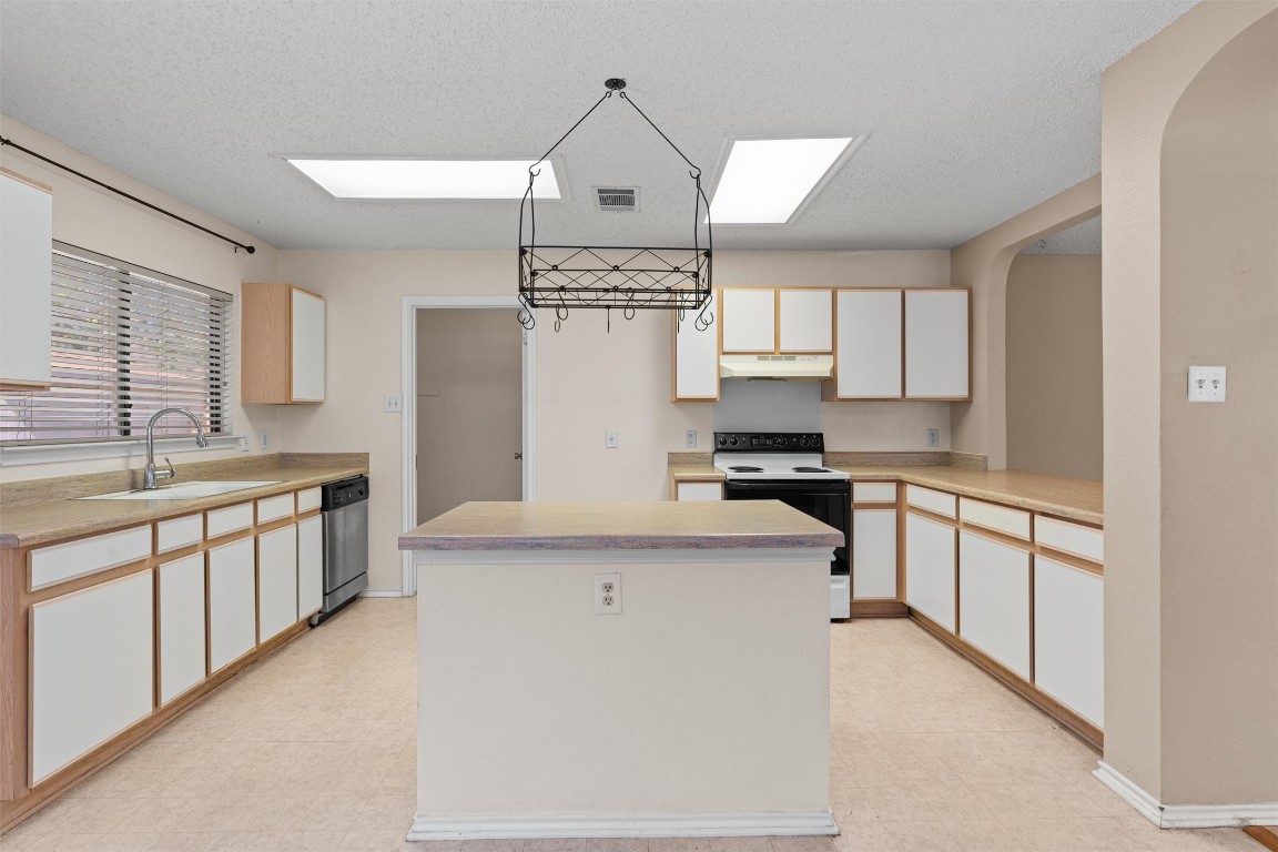 1353 Lakeside Loop Round Rock, TX 78665 - Photo 10 of 29 a large kitchen with stainless steel appliances granite countertop a stove a sink and a refrigerator