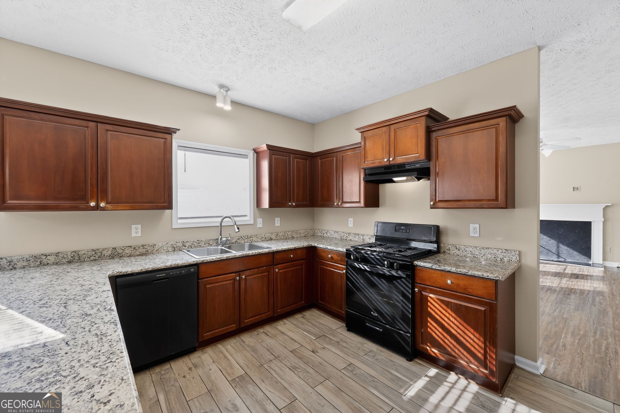 15 Parc Lane Covington, GA 30016 - Photo 14 of 30 a kitchen with stainless steel appliances granite countertop wooden cabinets a stove top oven a sink and dishwasher