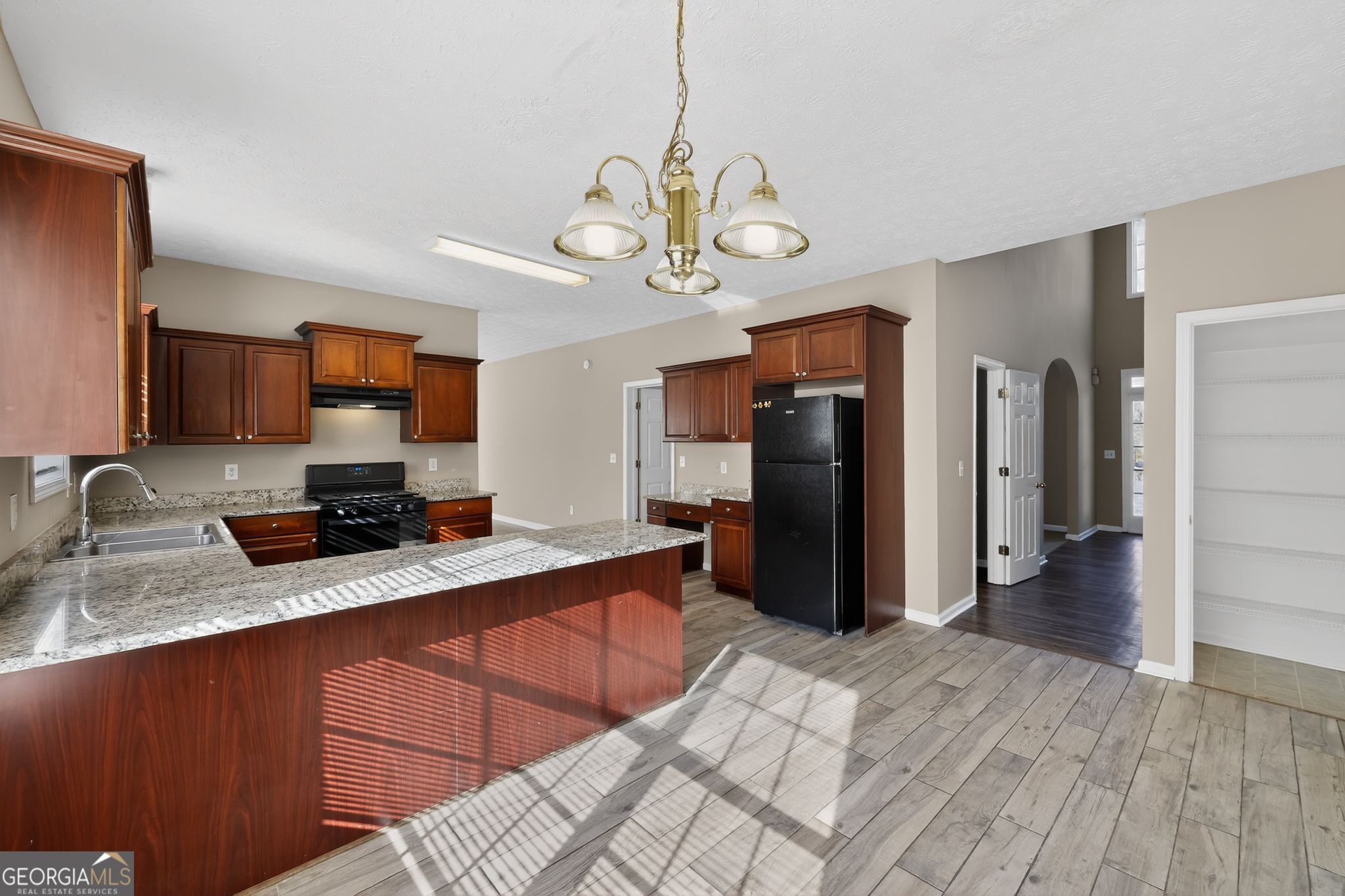 15 Parc Lane Covington, GA 30016 - Photo 15 of 30 a large kitchen with stainless steel appliances granite countertop a refrigerator a sink dishwasher a kitchen island with wooden floor and cabinets