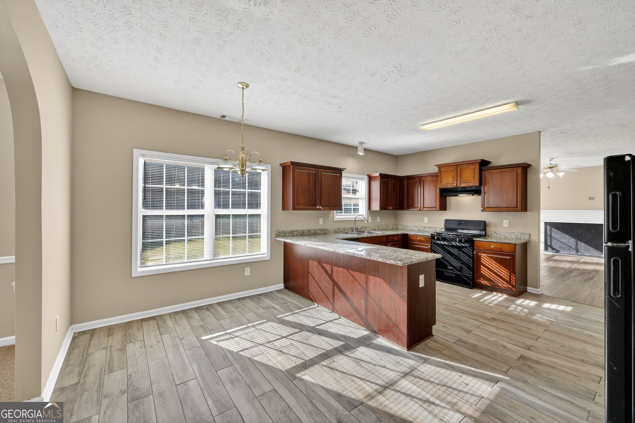 15 Parc Lane Covington, GA 30016 - Photo 17 of 30 a large kitchen with stainless steel appliances granite countertop a stove and a wooden floors
