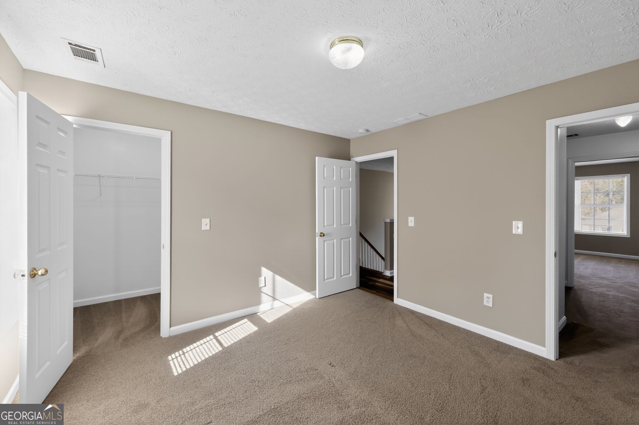 15 Parc Lane Covington, GA 30016 - Photo 18 of 30 a view of a room with an empty space and wooden shelves