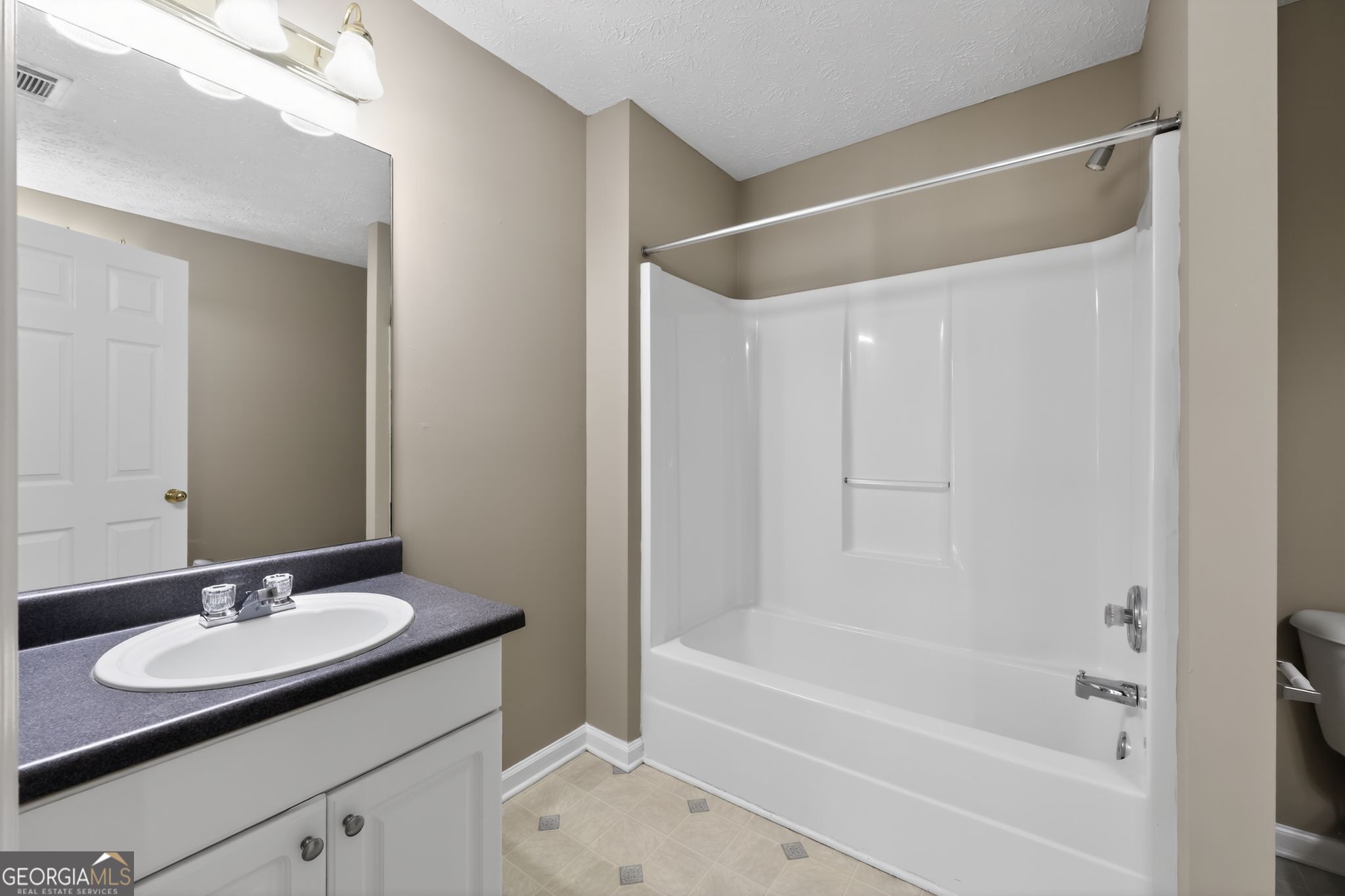 15 Parc Lane Covington, GA 30016 - Photo 22 of 30 a bathroom with a sink and a mirror