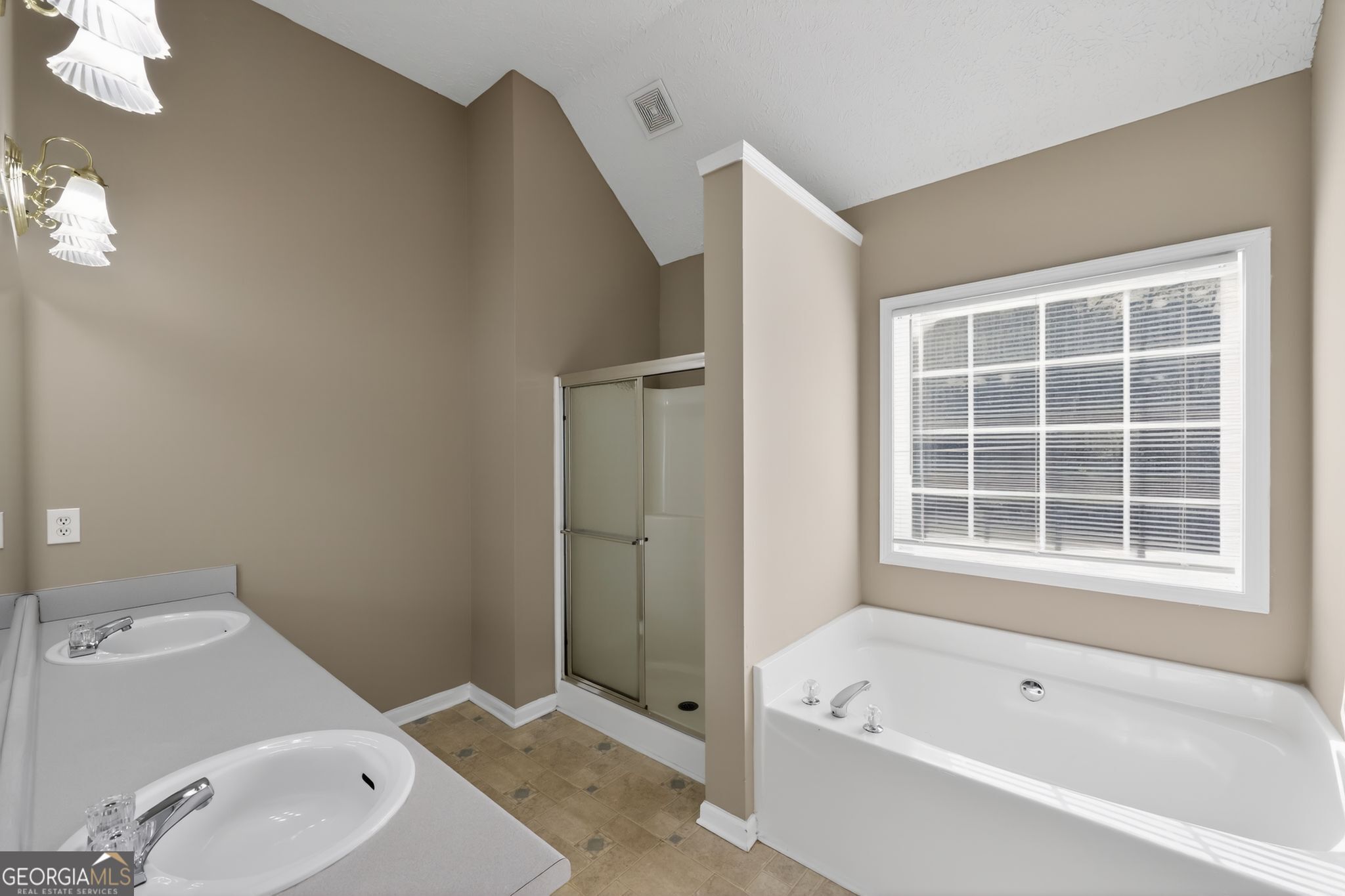 15 Parc Lane Covington, GA 30016 - Photo 23 of 30 a bathroom with a bathtub and a sink