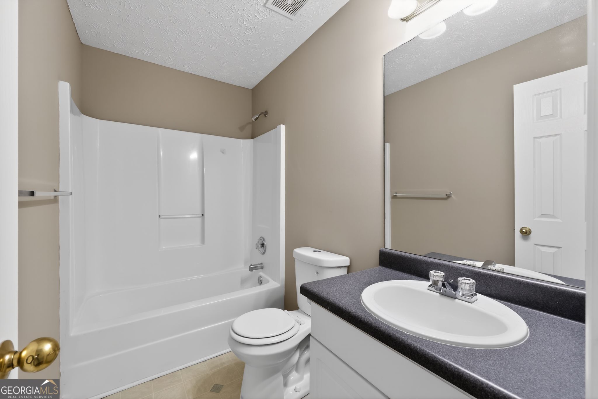 15 Parc Lane Covington, GA 30016 - Photo 24 of 30 a bathroom with a sink a toilet and shower