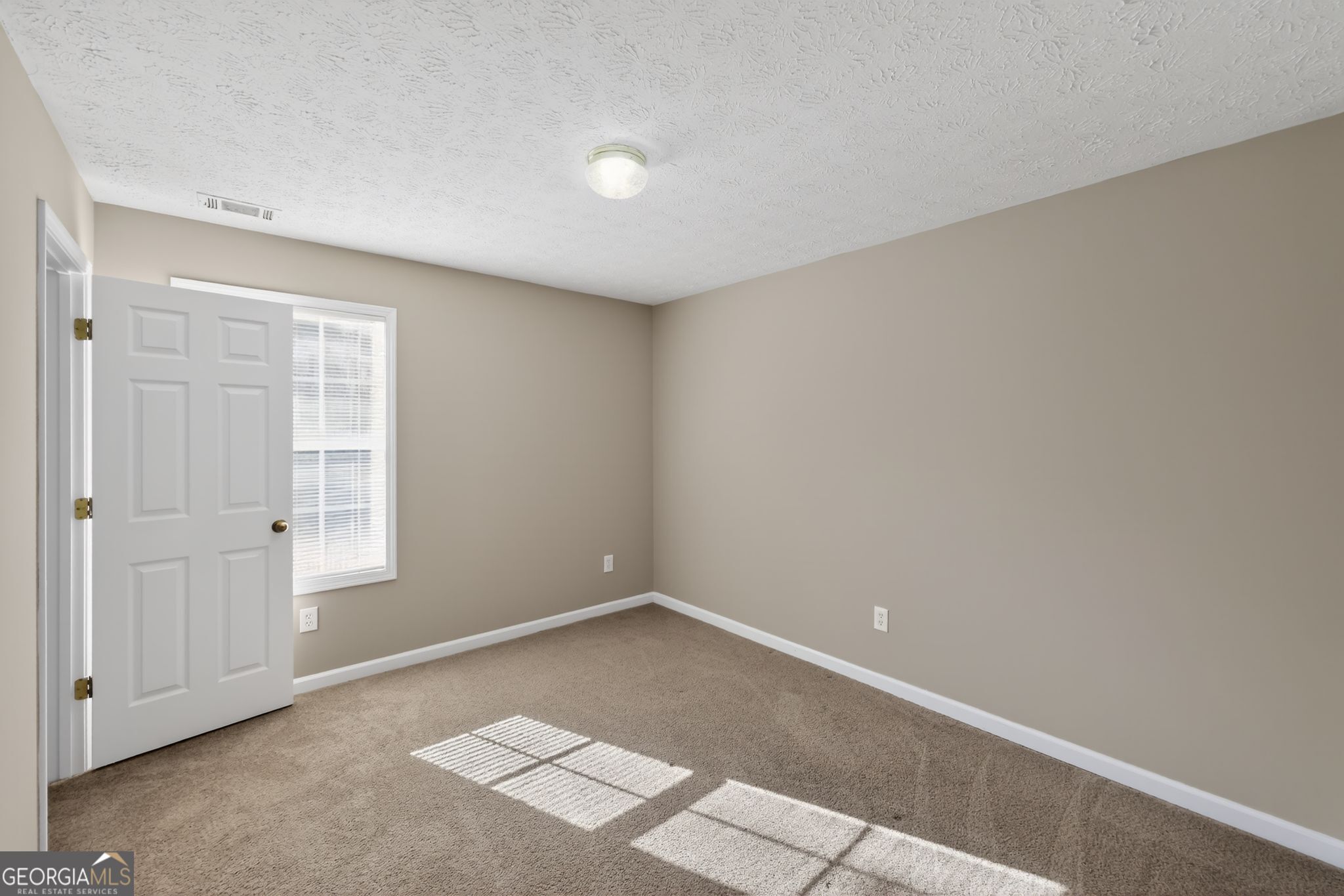 15 Parc Lane Covington, GA 30016 - Photo 5 of 30 a view of an empty room and window