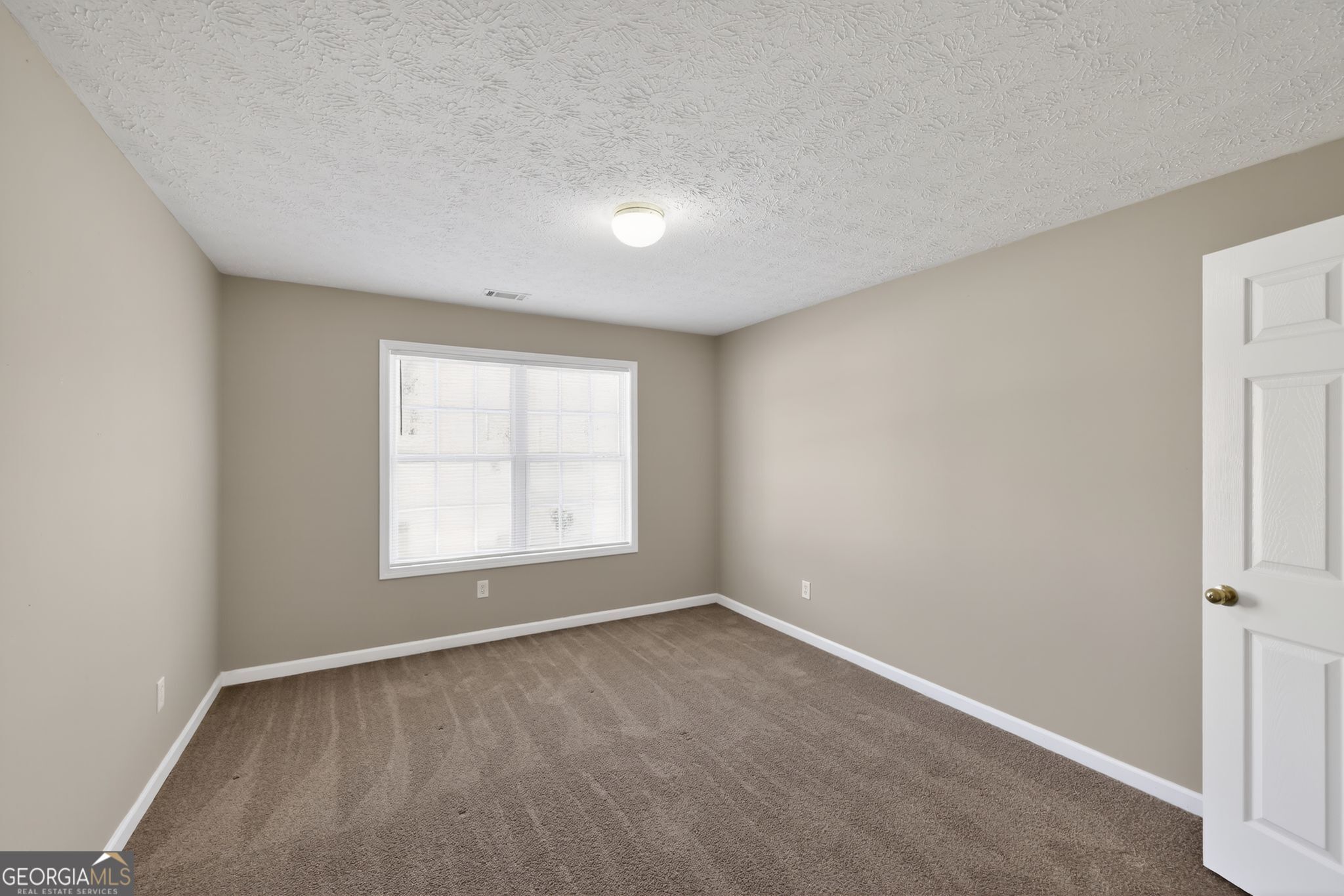 15 Parc Lane Covington, GA 30016 - Photo 8 of 30 an empty room with a window