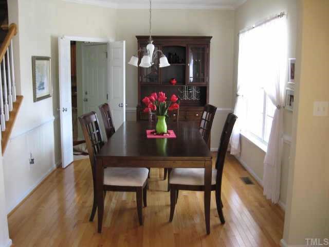 3521 Weir Way Raleigh, NC 27616 - Photo 3 of 12 a view of a dining room with furniture and wooden floor