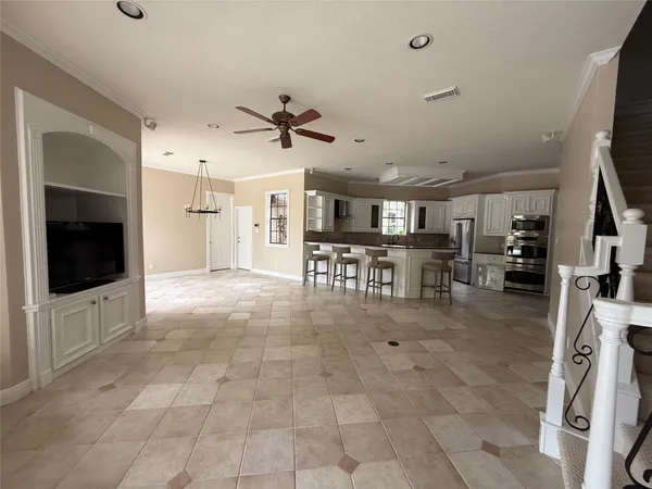 a view of a living room a flat screen tv and kitchen view