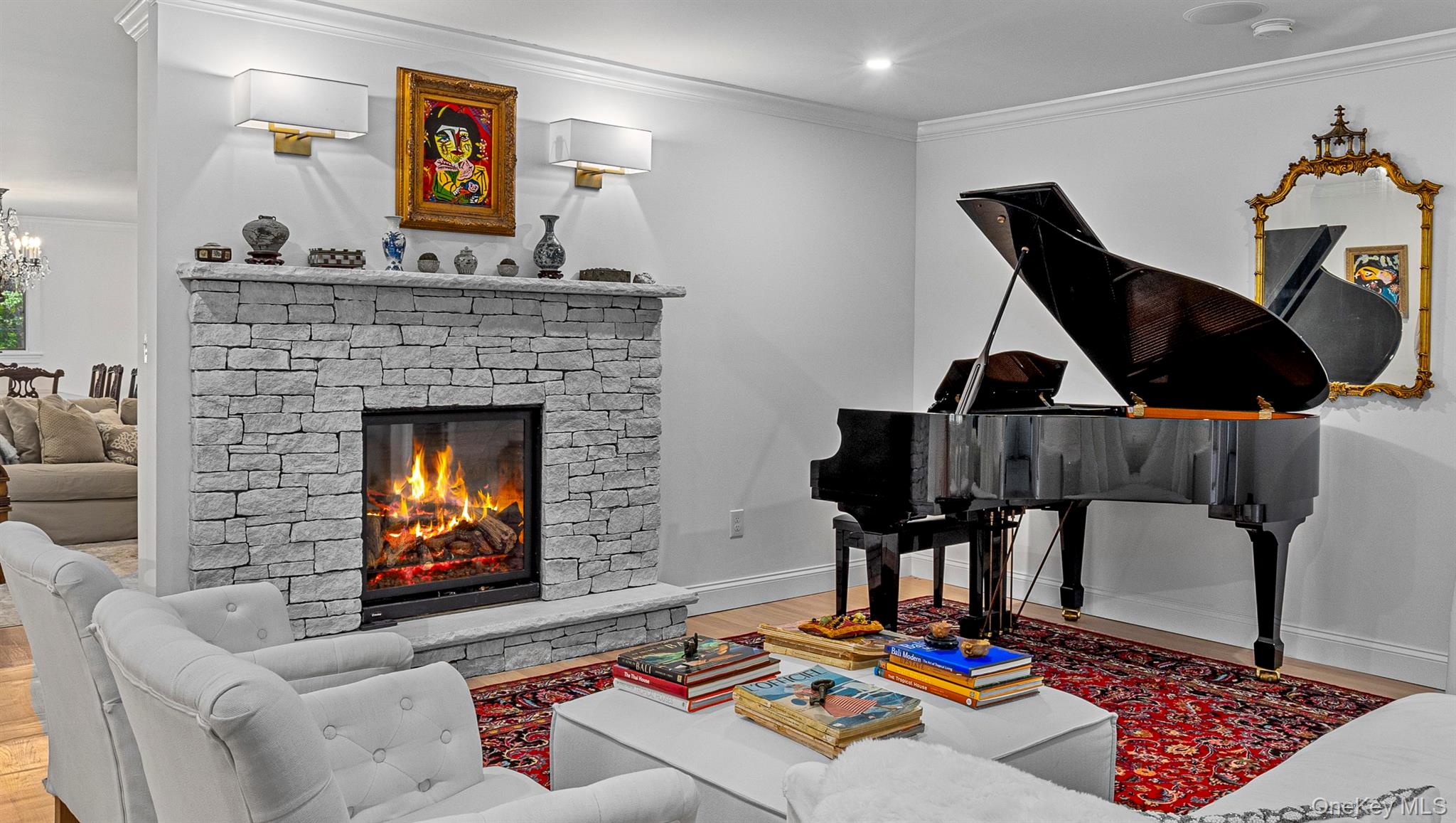 78 Schultz Hill Road Staatsburg, NY 12580 - Photo 14 of 50 Living area with wood finished floors, crown molding, a chandelier, baseboards, and a stone fireplace