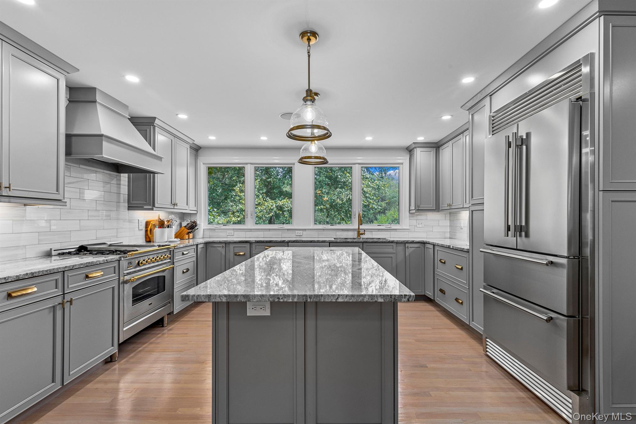 78 Schultz Hill Road Staatsburg, NY 12580 - Photo 17 of 50 Kitchen featuring high quality appliances, gray cabinets, premium range hood, a sink, and a center island