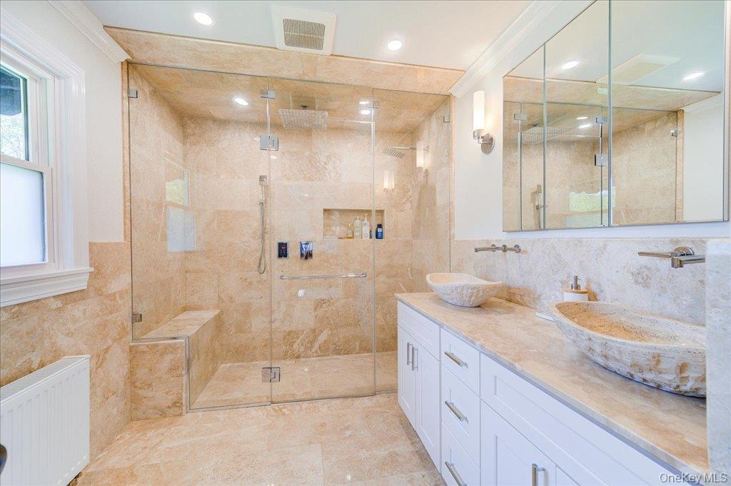 78 Schultz Hill Road Staatsburg, NY 12580 - Photo 33 of 50 Bathroom with radiator, tile walls, a shower stall, double vanity, and recessed lighting
