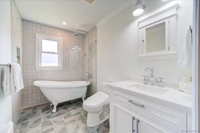 a kitchen with granite countertop a stove a sink and a refrigerator