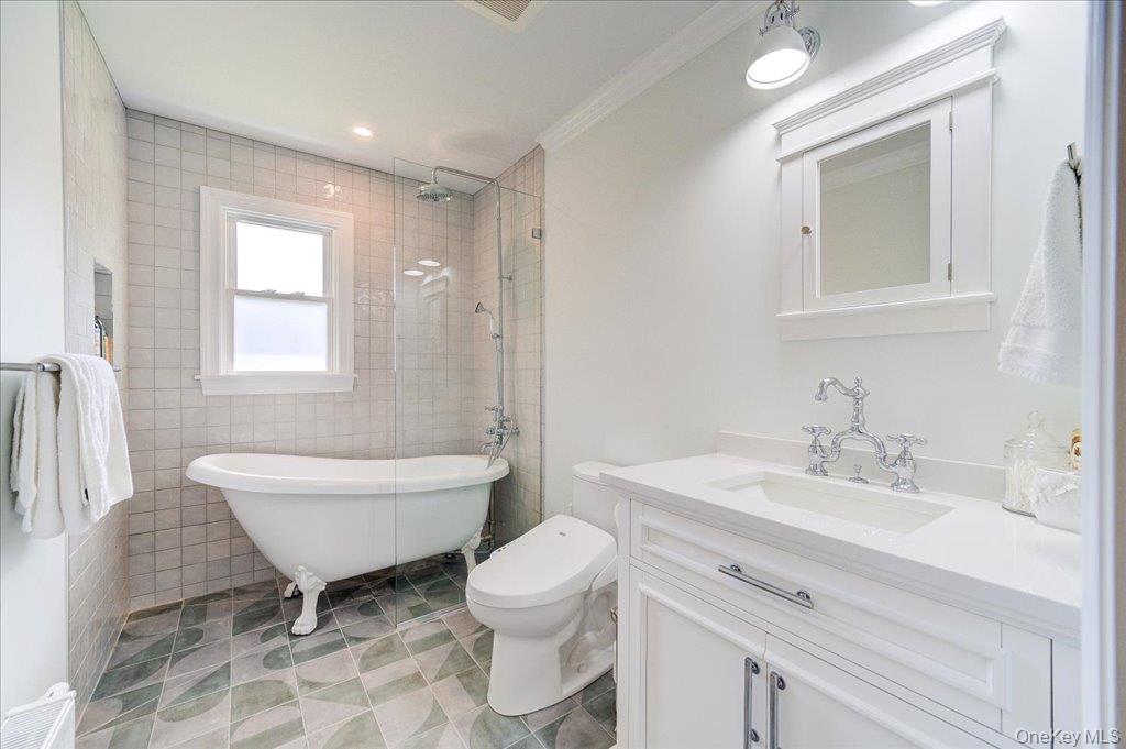 78 Schultz Hill Road Staatsburg, NY 12580 - Photo 37 of 50 Bathroom with vanity, tiled shower, a soaking tub, toilet, and tile walls