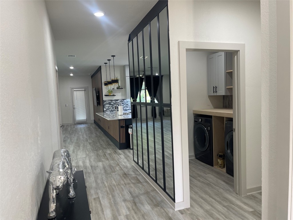 145 Merrick Road Georgetown, TX 78628 - Photo 10 of 33 a view of hallway with wooden floor and stairs