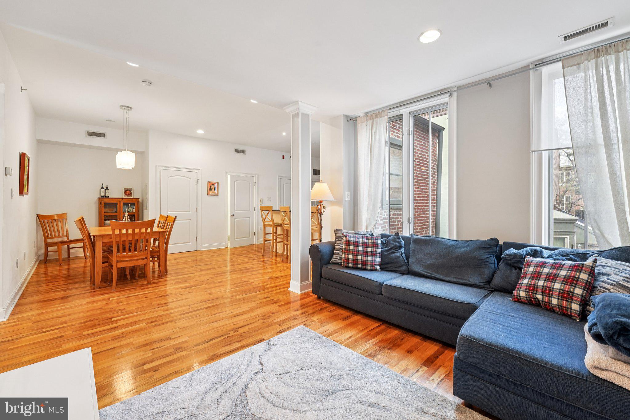 920 Clinton Street, Unit 3R Philadelphia, PA 19107 - Photo 12 of 24 a living room with furniture and a large window