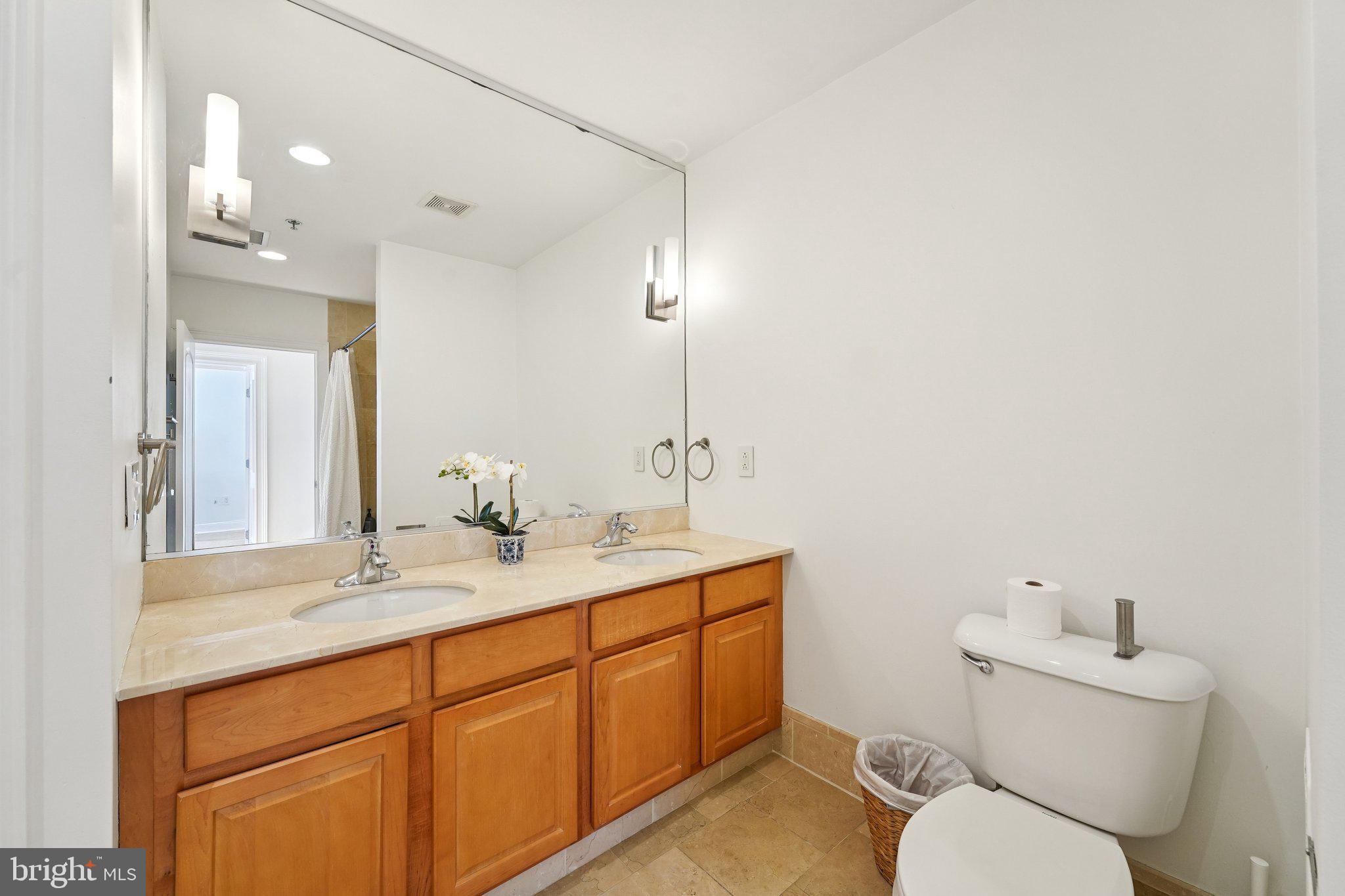 920 Clinton Street, Unit 3R Philadelphia, PA 19107 - Photo 19 of 24 a bathroom with a toilet sink and mirror
