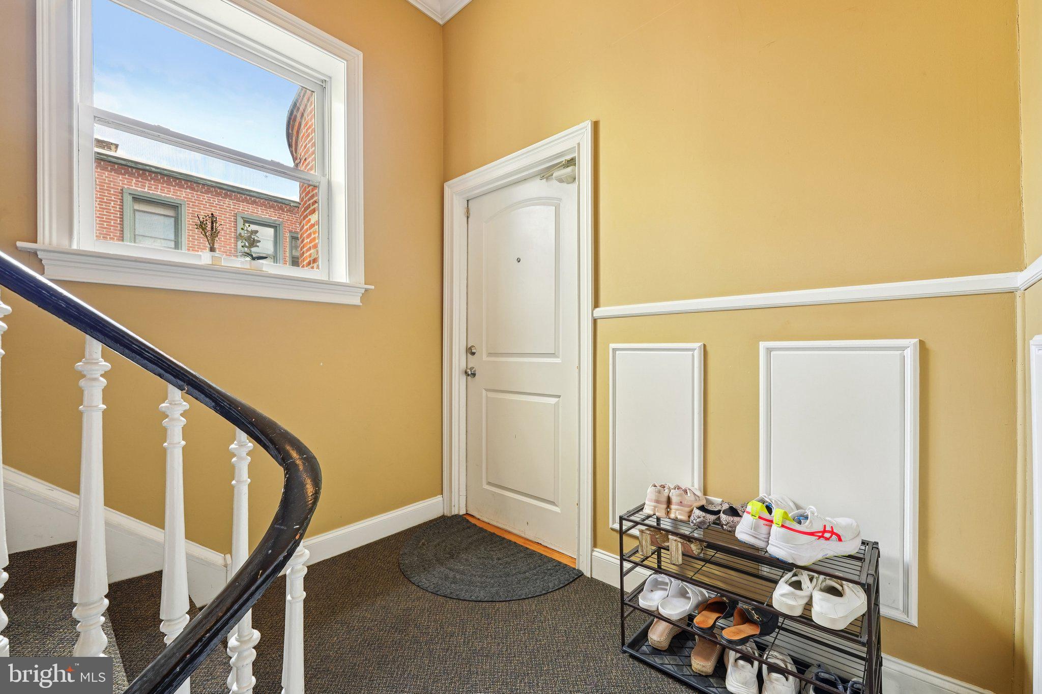 920 Clinton Street, Unit 3R Philadelphia, PA 19107 - Photo 22 of 24 a living room with furniture and a window