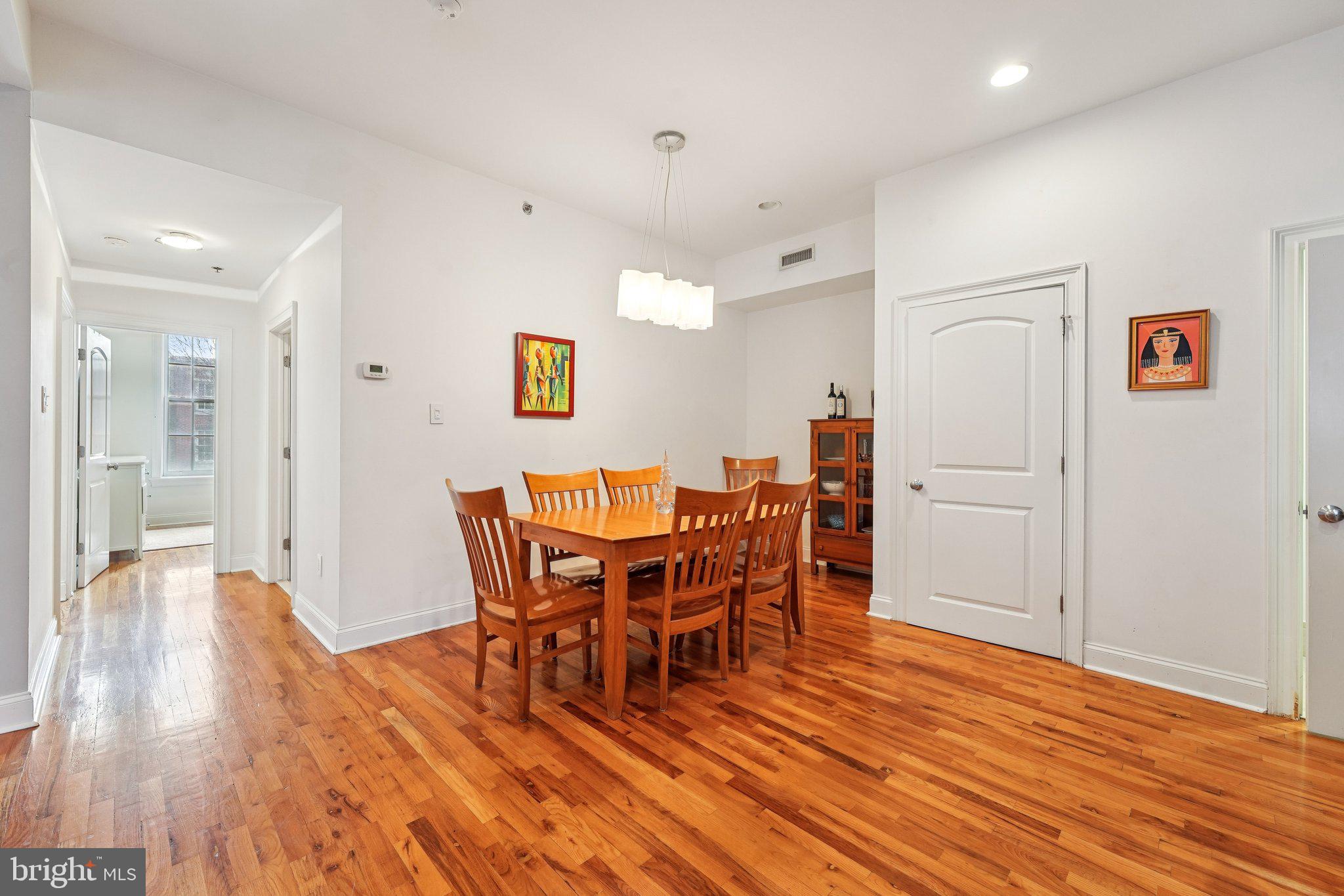 920 Clinton Street, Unit 3R Philadelphia, PA 19107 - Photo 10 of 24 a view of a dining room with furniture and wooden floor