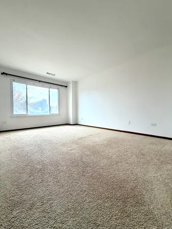 an empty room with a empty space and a window