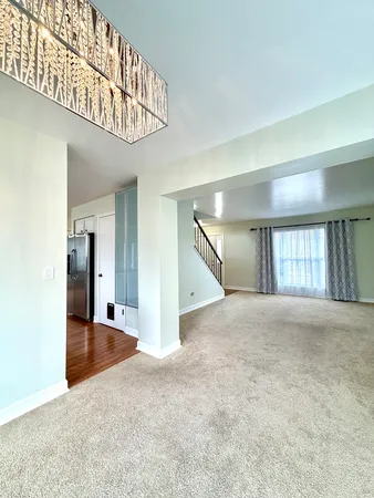 an empty room with windows and entryway